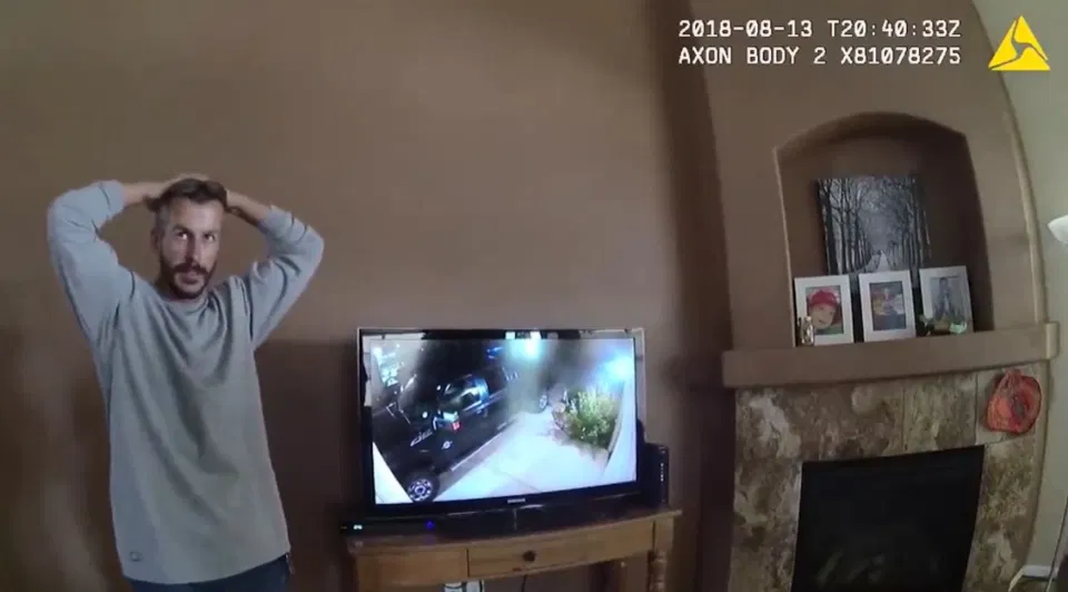 Chris Watts at his neighbours house, not watching the security camera footage from the day when his wife and kids disappears. 